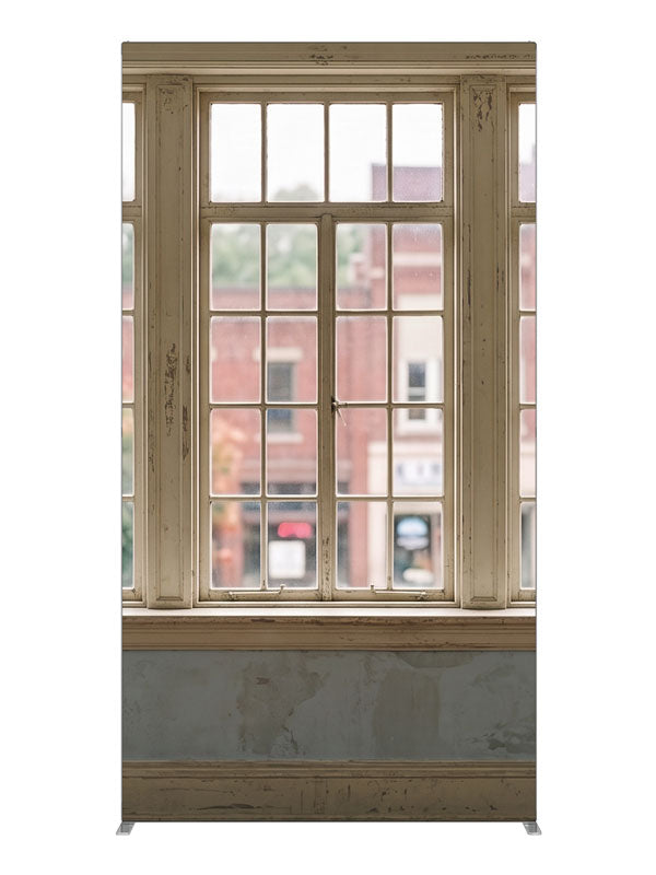 Weathered cream multi-pane windows overlooking a small-town brick main street, 4ft photography backdrop panel for Denny StudioEdge silicone edge frame