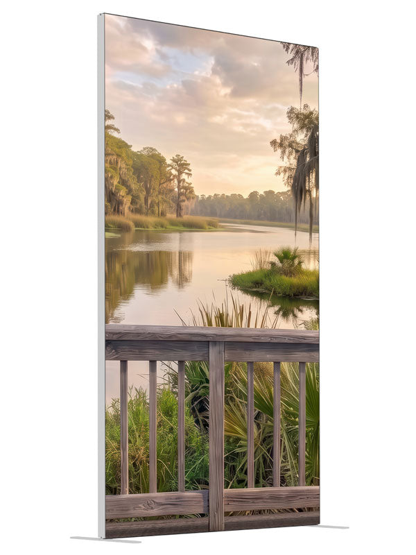 Weathered railing over a southern bayou with moss-draped cypress at peach sunset, 4ft photography backdrop panel for Denny StudioEdge silicone edge frame, angled view