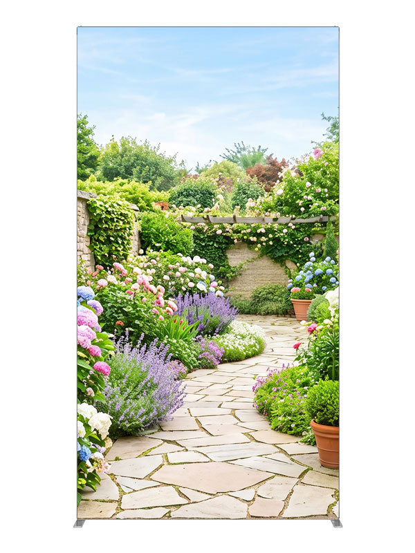 A flagstone path through a dense spring garden of hydrangeas, lavender and roses with a stone wall and pergola, 4ft photography backdrop panel for Denny StudioEdge silicone edge frame
