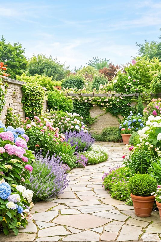 A flagstone path through a dense spring garden of hydrangeas, lavender and roses with a stone wall and pergola, 5ft photography backdrop panel for Denny StudioEdge silicone edge frame