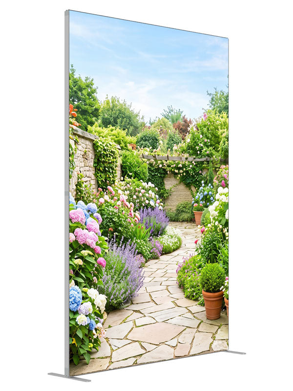 A flagstone path through a dense spring garden of hydrangeas, lavender and roses with a stone wall and pergola, 5ft photography backdrop panel for Denny StudioEdge silicone edge frame, angled view