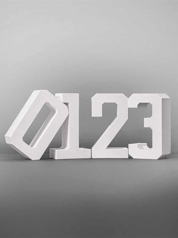 White hard-coated foam stand-alone number props arranged as 0 1 2 3 on a gray studio background.