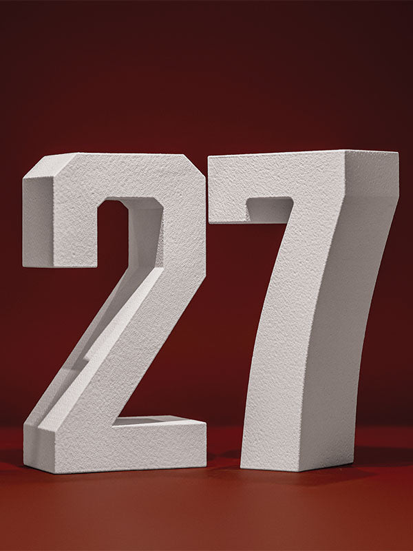 White hard-coated foam stand-alone number props showing 27 on a deep red background.