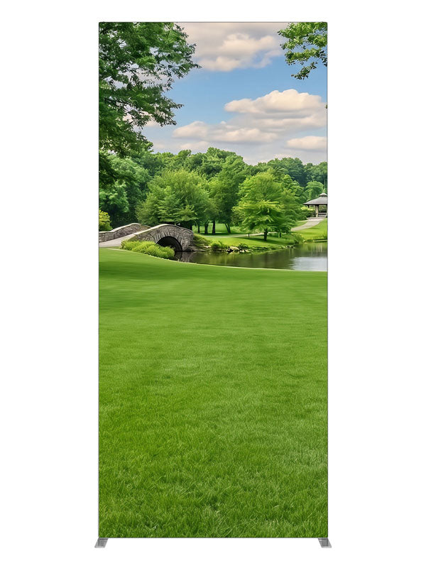 A groomed park lawn with a pond, arched stone bridge and a gazebo framed by trees, 3ft photography backdrop panel for Denny StudioEdge silicone edge frame