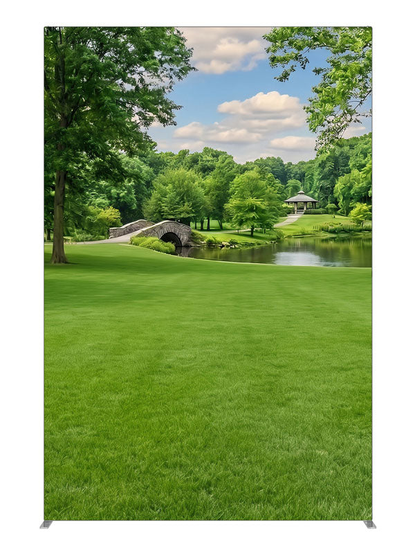A groomed park lawn with a pond, arched stone bridge and a gazebo framed by trees, 5ft photography backdrop panel for Denny StudioEdge silicone edge frame