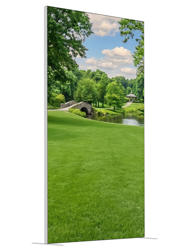 A groomed park lawn with a pond, arched stone bridge and a gazebo framed by trees, 4ft photography backdrop panel for Denny StudioEdge silicone edge frame, angled view