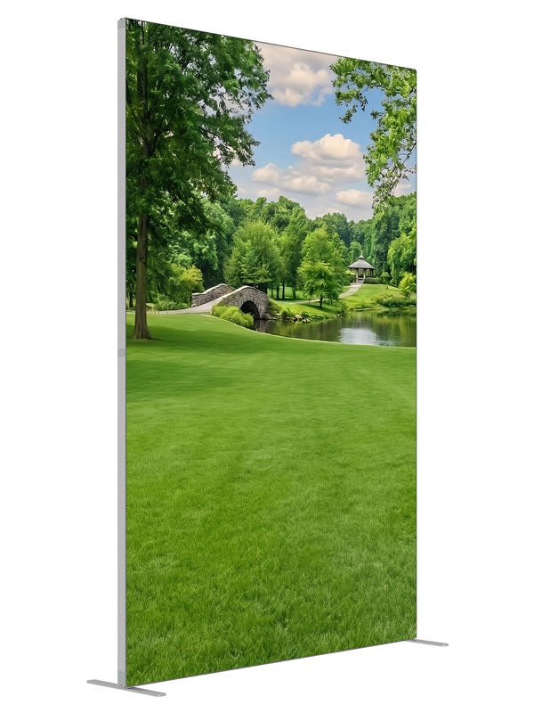 A groomed park lawn with a pond, arched stone bridge and a gazebo framed by trees, 5ft photography backdrop panel for Denny StudioEdge silicone edge frame, angled view
