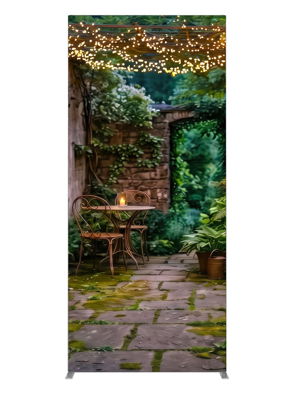 A garden courtyard at dusk under a pergola strung with warm fairy lights, with a bistro table and ferns, 3ft photography backdrop panel for Denny StudioEdge silicone edge frame