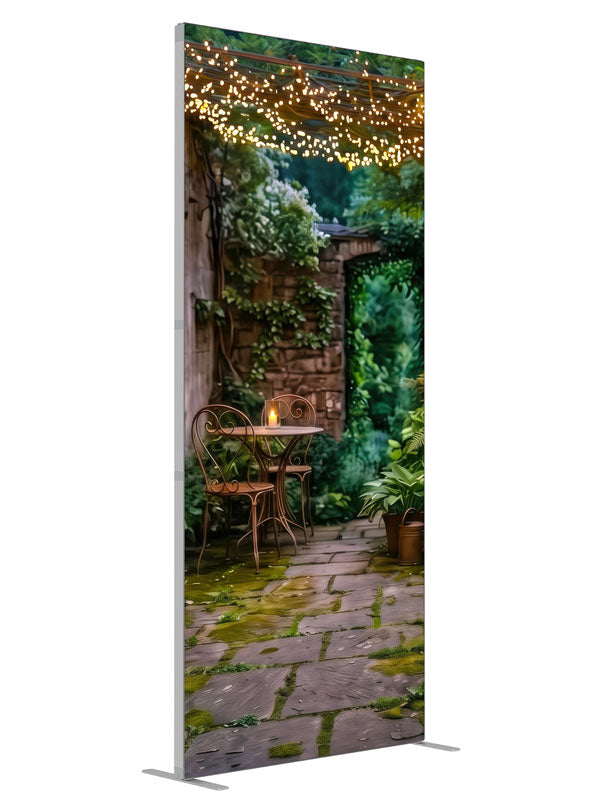 A garden courtyard at dusk under a pergola strung with warm fairy lights, with a bistro table and ferns, 3ft photography backdrop panel for Denny StudioEdge silicone edge frame, angled view