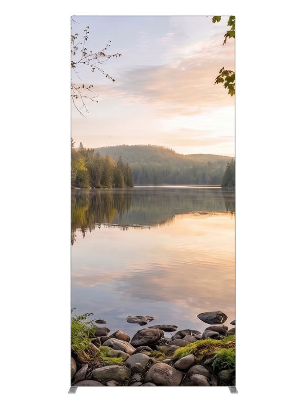 Still forest lake at sunrise with a mirrored peach sky and a mossy stone shoreline, 3ft photography backdrop panel for Denny StudioEdge silicone edge frame