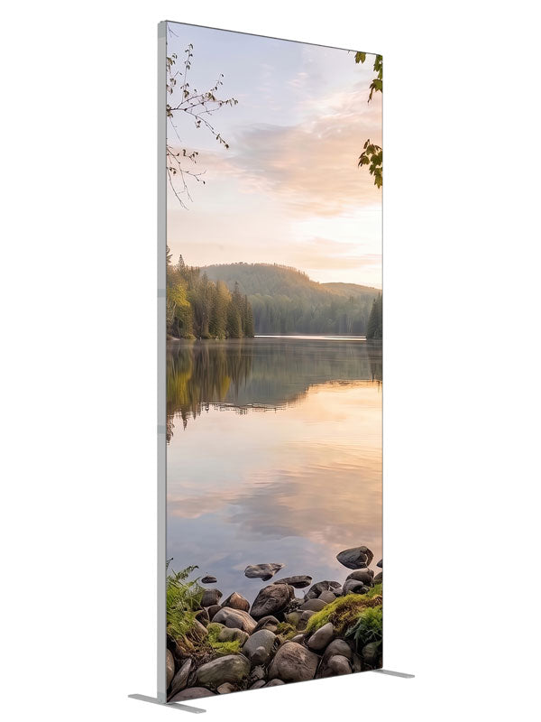 Still forest lake at sunrise with a mirrored peach sky and a mossy stone shoreline, 3ft photography backdrop panel for Denny StudioEdge silicone edge frame, angled view