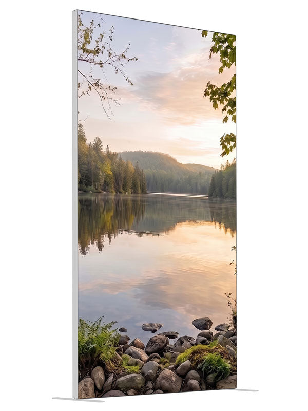 Still forest lake at sunrise with a mirrored peach sky and a mossy stone shoreline, 4ft photography backdrop panel for Denny StudioEdge silicone edge frame, angled view