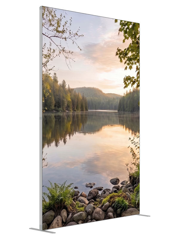 Still forest lake at sunrise with a mirrored peach sky and a mossy stone shoreline, 5ft photography backdrop panel for Denny StudioEdge silicone edge frame, angled view