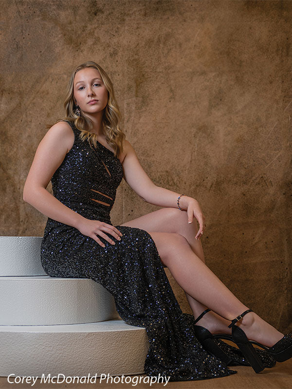 Textured Gold Radiance printed photography backdrop shown in a styled studio session with a senior in a black sequin gown seated on white posing steps with a poised expression OM-2606