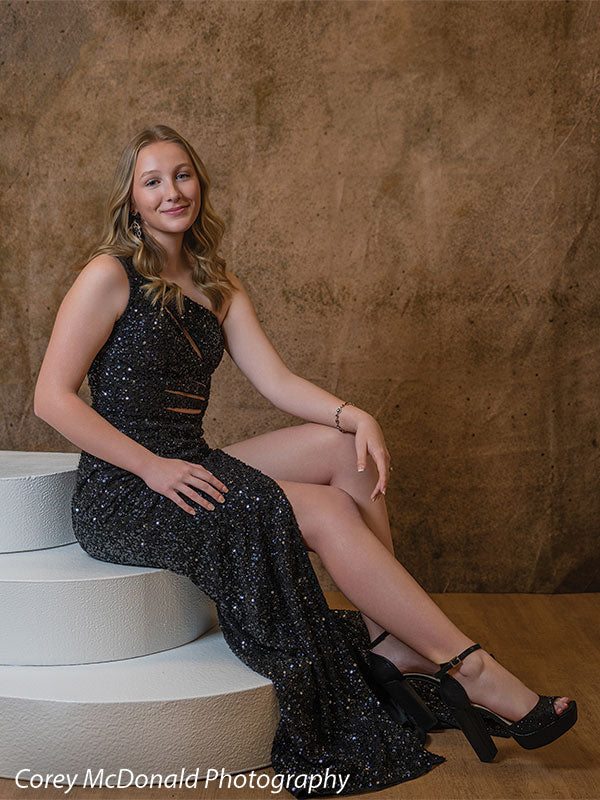 Textured Gold Radiance printed photography backdrop shown in a styled studio session with a senior in a black sequin gown seated on white posing steps, smiling OM-2606
