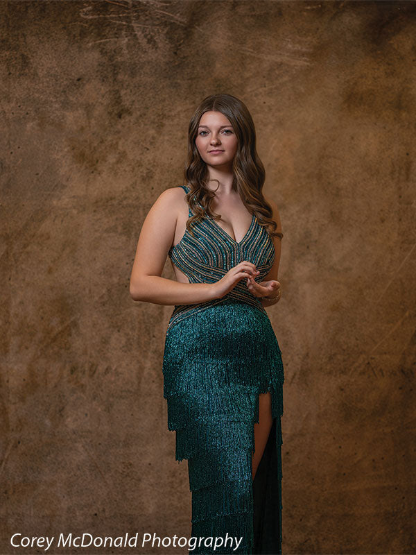 Textured Gold Radiance printed photography backdrop shown in a styled studio session with a senior in a teal fringed gown standing full-length with hands together OM-2606