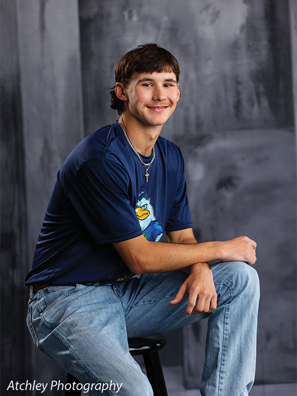 Textured Gray multi-panel photography backdrop shown with a senior athlete in a navy jersey seated on a stool CP-8817