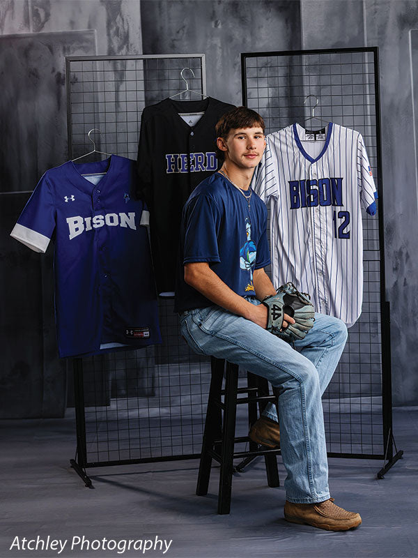 Textured Gray multi-panel photography backdrop shown with a senior athlete seated beside a jersey display rack CP-8817