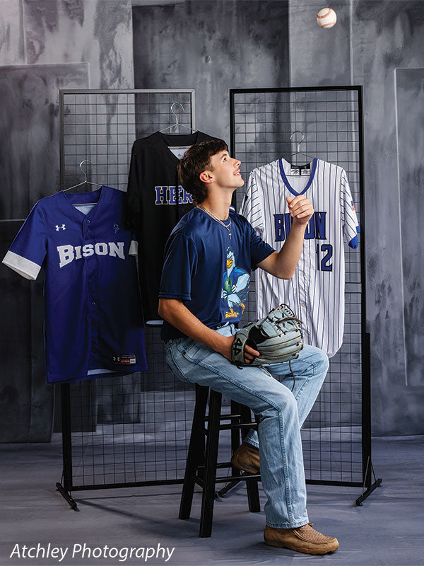 Textured Gray multi-panel photography backdrop shown with a senior athlete seated tossing a baseball beside a jersey rack CP-8817