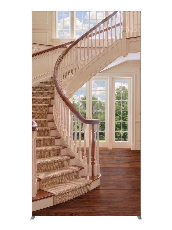 A cream curved staircase in a bright two-story foyer with tall windows and open hardwood floor, 4ft photography backdrop panel for Denny StudioEdge silicone edge frame