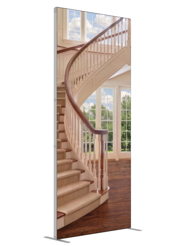 A cream curved staircase in a bright two-story foyer with tall windows and open hardwood floor, 3ft photography backdrop panel for Denny StudioEdge silicone edge frame, angled view