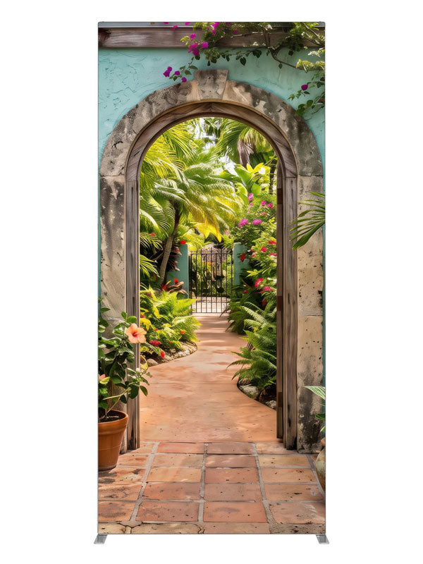 A turquoise stucco courtyard wall with a stone archway opening onto a lush tropical garden, 3ft photography backdrop panel for Denny StudioEdge silicone edge frame