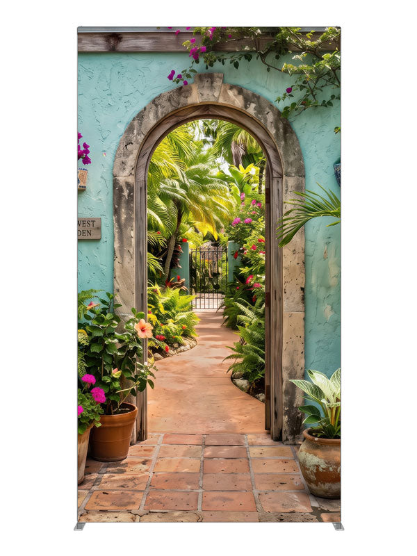 A turquoise stucco courtyard wall with a stone archway opening onto a lush tropical garden, 4ft photography backdrop panel for Denny StudioEdge silicone edge frame