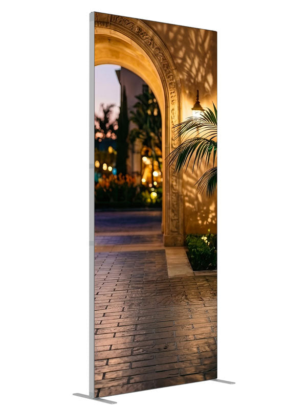 Warm stucco archway opening onto a twilight garden courtyard with a glazed urn and bokeh lights, 3ft photography backdrop panel for Denny StudioEdge silicone edge frame, angled view