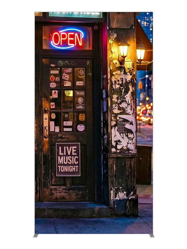 Gritty neon-lit city bar corner at night with live-music signage and a sticker-covered door, 4ft photography backdrop panel for Denny StudioEdge silicone edge frame