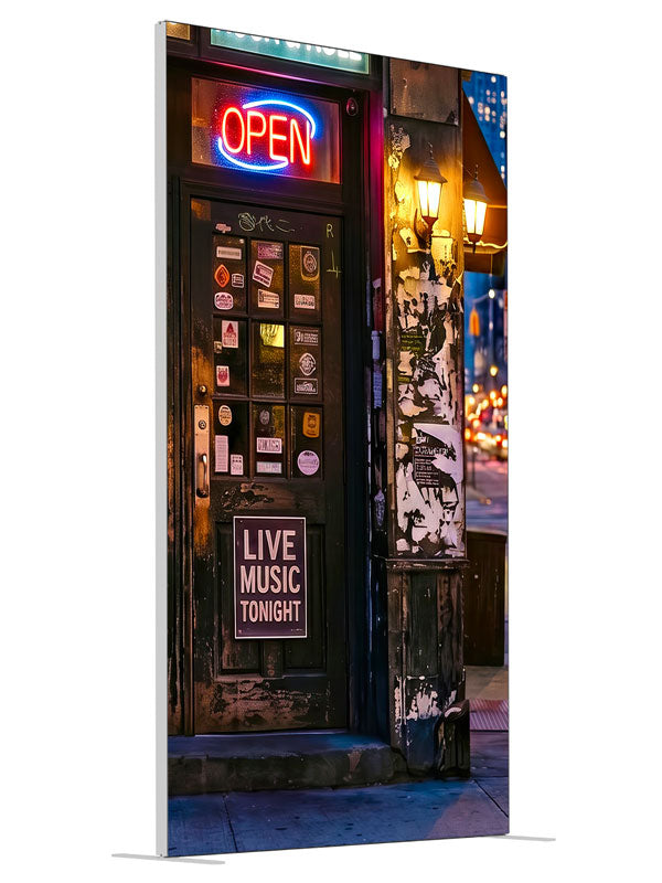 Gritty neon-lit city bar corner at night with live-music signage and a sticker-covered door, 4ft photography backdrop panel for Denny StudioEdge silicone edge frame, angled view