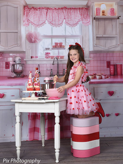 Baking-themed Valentine's Day kitchen backdrop featuring pink gingham and heart details for professional portrait sessions.