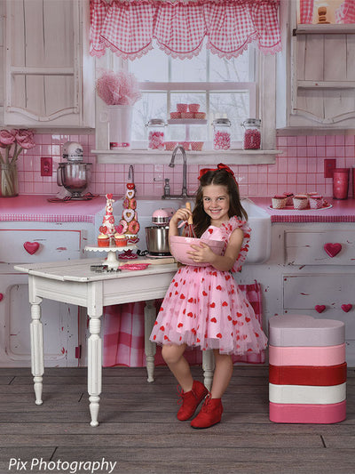 Festive Valentine's Day kitchen backdrop with heart decor and pink gingham accents for portrait photography and themed sessions.