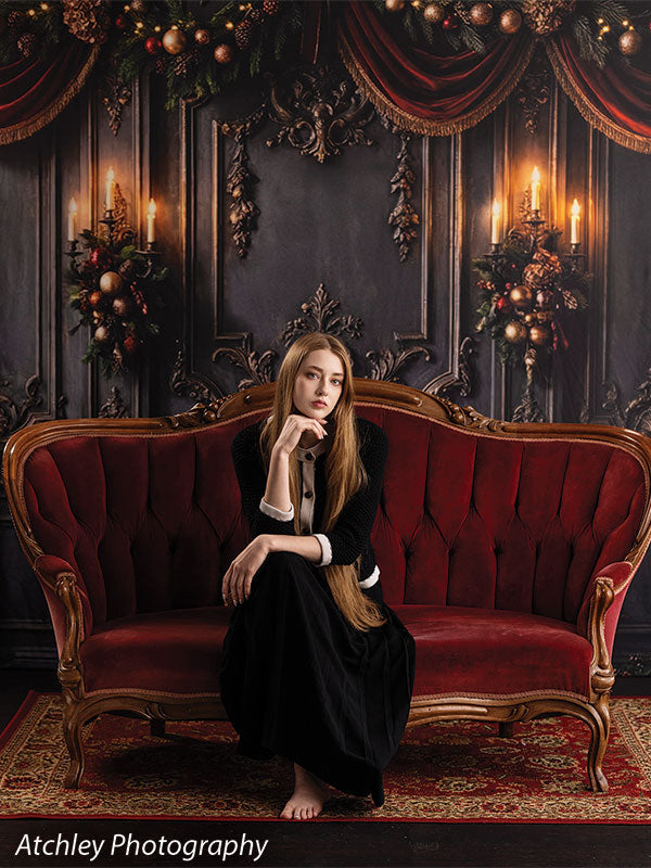 Velvet Swag ornate gray paneled wall with red velvet draping photography backdrop shown with a senior girl seated on the sofa resting her hand to her face CP-8899