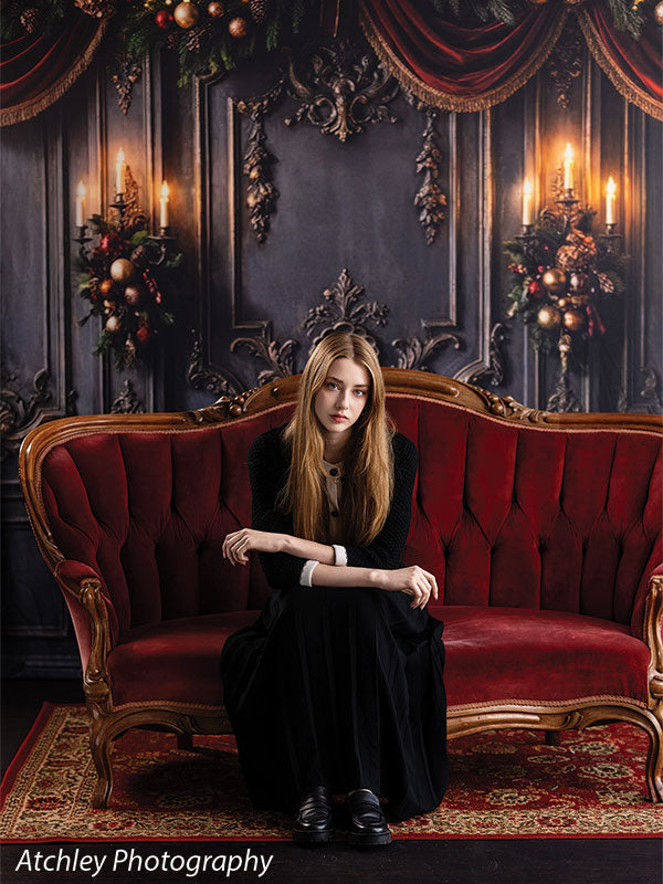 Velvet Swag ornate gray paneled wall with red velvet draping photography backdrop shown with a senior girl seated low on the red velvet sofa CP-8899