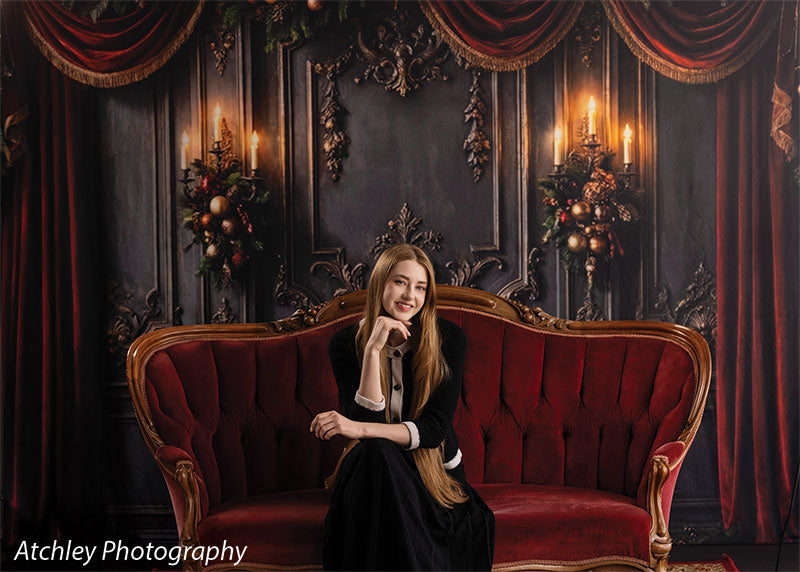 Velvet Swag ornate gray paneled wall with red velvet draping photography backdrop shown with a senior girl seated on the red velvet sofa, relaxed, wide view CP-8899