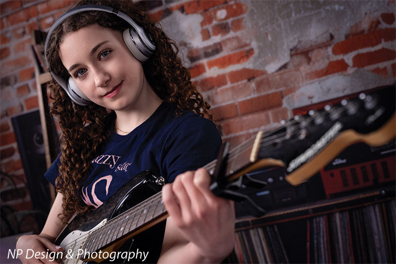 Vintage exposed brick music studio photography backdrop shown with a senior girl wearing headphones playing an electric guitar CP-8630