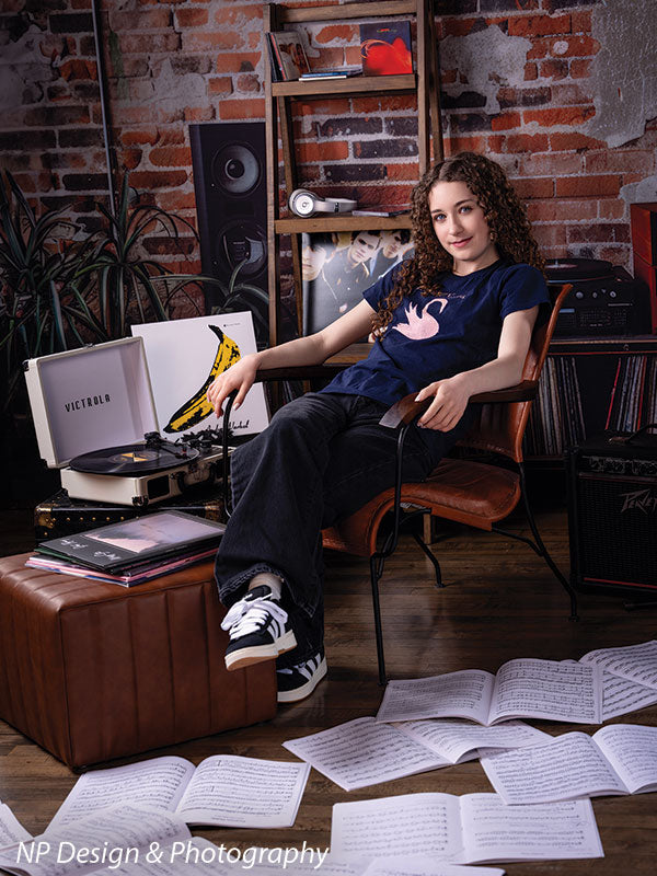 Vintage exposed brick music studio photography backdrop shown with a senior girl seated with her legs crossed beside a turntable CP-8630