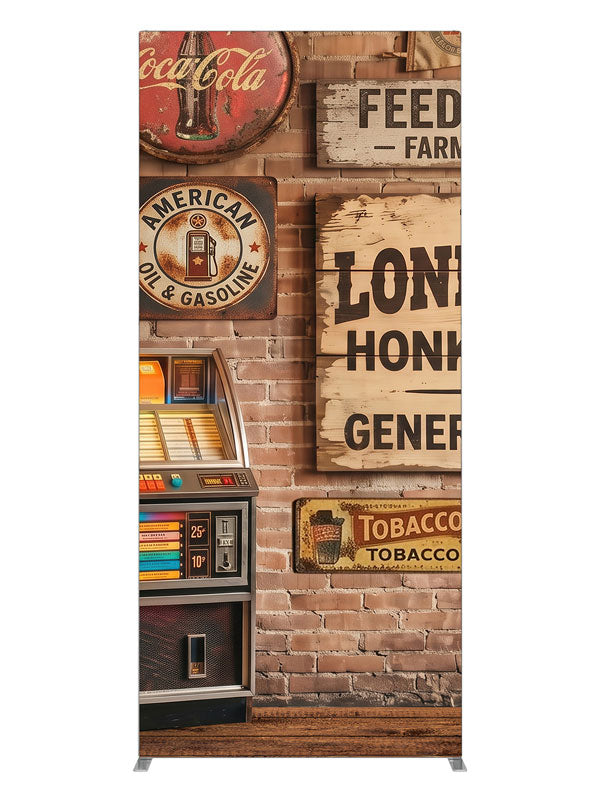 A lit retro jukebox against a red-brick wall of vintage-style roadhouse signage over a plank floor, 3ft photography backdrop panel for Denny StudioEdge silicone edge frame