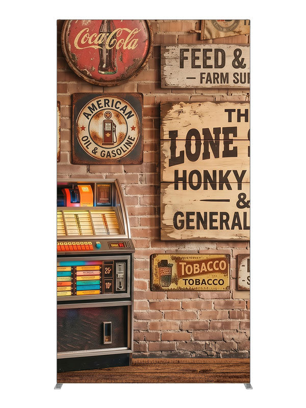 A lit retro jukebox against a red-brick wall of vintage-style roadhouse signage over a plank floor, 4ft photography backdrop panel for Denny StudioEdge silicone edge frame