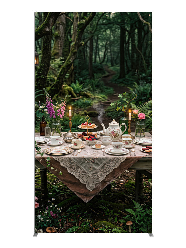 A storybook tea-party table with florals and candlelight set in a mossy enchanted forest with lanterns, 4ft photography backdrop panel for Denny StudioEdge silicone edge frame