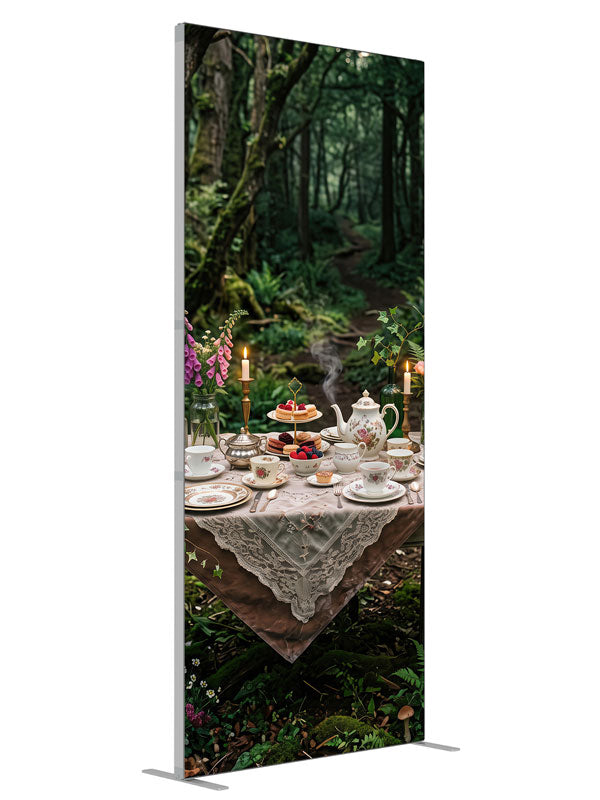 A storybook tea-party table with florals and candlelight set in a mossy enchanted forest with lanterns, 3ft photography backdrop panel for Denny StudioEdge silicone edge frame, angled view