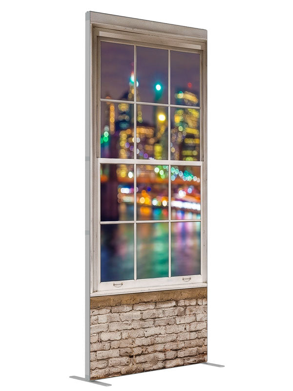 A whitewashed-brick loft with white-framed windows over a colorful bokeh city skyline at night, 3ft photography backdrop panel for Denny StudioEdge silicone edge frame