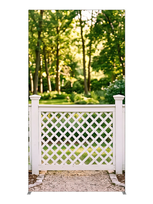 White lattice garden fence with square-capped posts against a sunlit green tree canopy, 4ft photography backdrop panel for Denny StudioEdge silicone edge frame