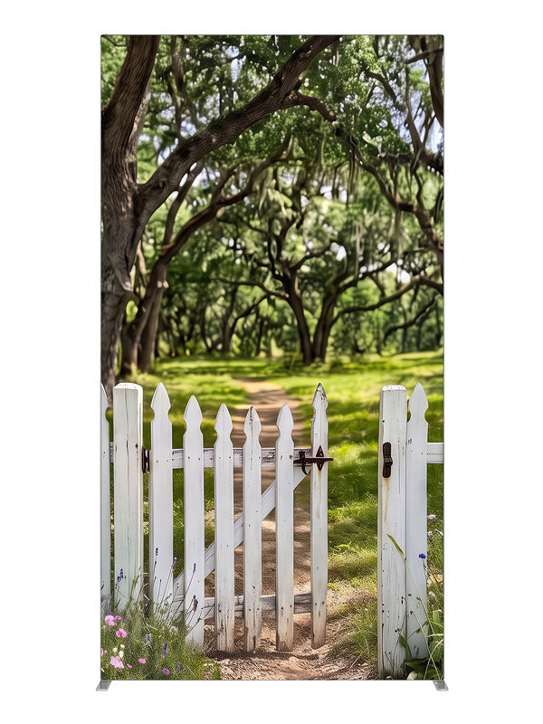 Open white picket gate in a low fence with a dirt path leading into a moss-draped live oak grove, 4ft photography backdrop panel for Denny StudioEdge silicone edge frame