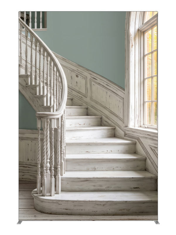 A distressed whitewashed curved staircase with sage walls and an arched window onto sunlit palms, 5ft photography backdrop panel for Denny StudioEdge silicone edge frame
