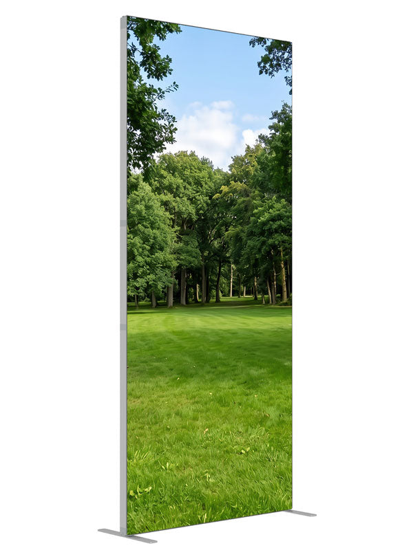 A shaded park clearing of flat lawn framed by two large trees with woodland behind, 3ft photography backdrop panel for Denny StudioEdge silicone edge frame, angled view