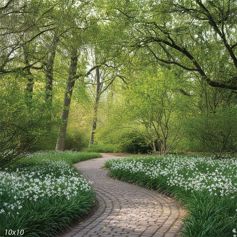 A wider view of a curving stone walkway surrounded by fresh green trees and dense white blooms, creating a peaceful spring garden setting.