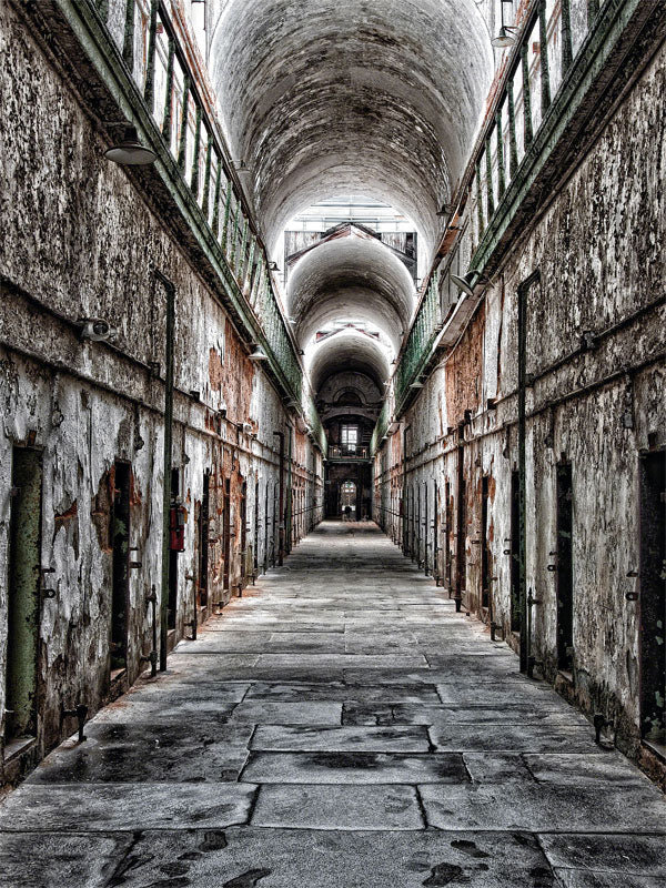 Abandoned Prison Corridor Photography Backdrop - Long, narrow corridor of an abandoned prison with aged concrete walls, rusty cell doors, and a high arched ceiling, perfect for eerie photoshoots.