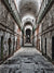 Abandoned Prison Corridor Photography Backdrop - Long, narrow corridor of an abandoned prison with aged concrete walls, rusty cell doors, and a high arched ceiling, perfect for eerie photoshoots.
