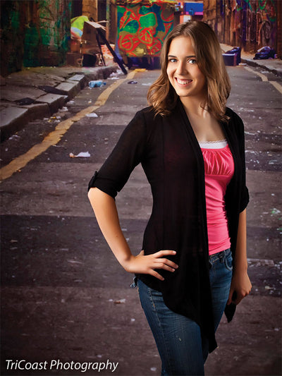 Backdrop highlighting city life through detailed spray-painted walls and pavement.